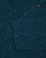Close-up view of cuff, placket and corozo buttons of organic corduroy, petrol blue blazer from Uskees.