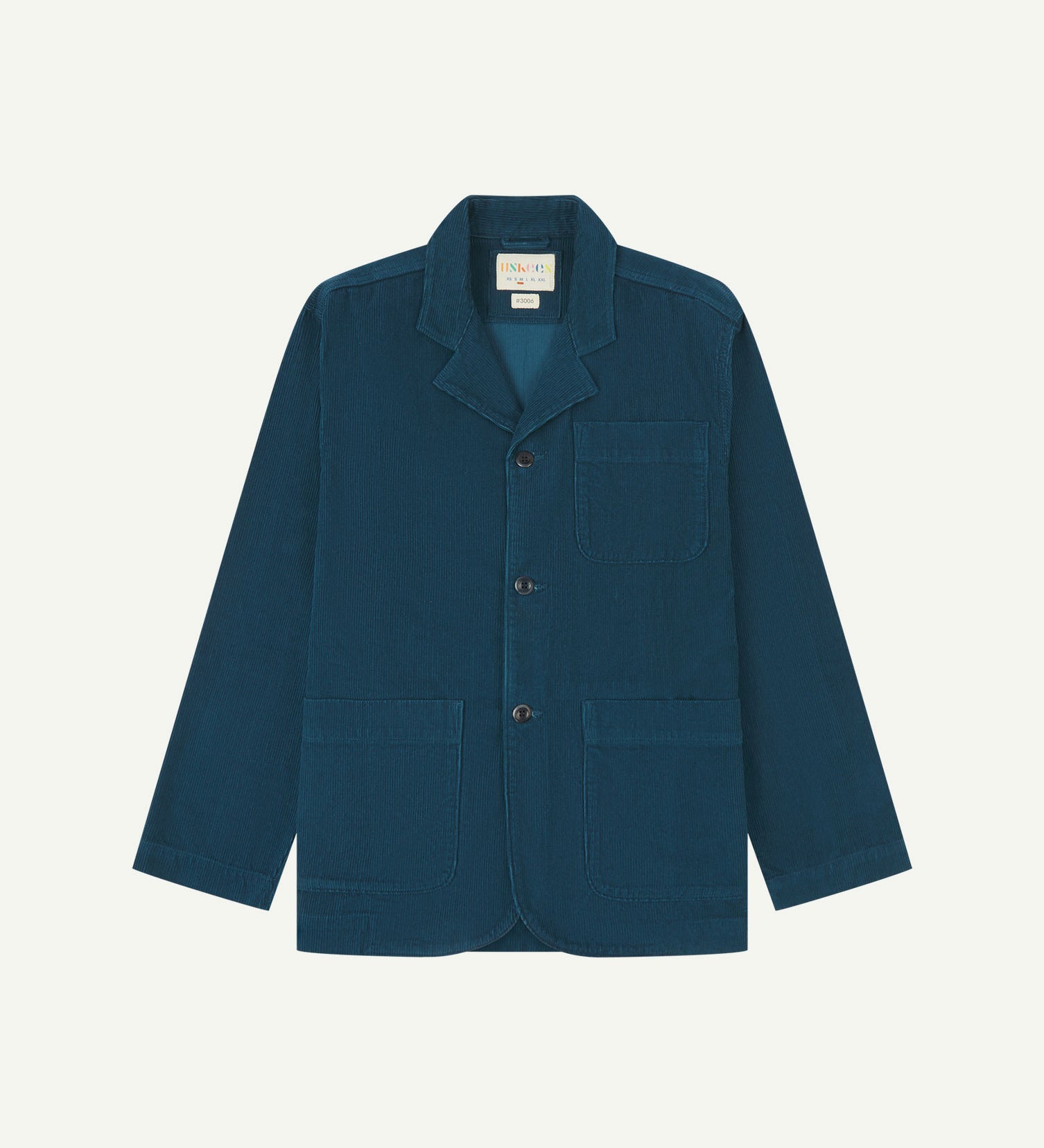 Flat front view of men's corduroy petrol blue blazer with 3 patch pockets from Uskees. Clearly showing corozo buttons and 3 pockets on the front.