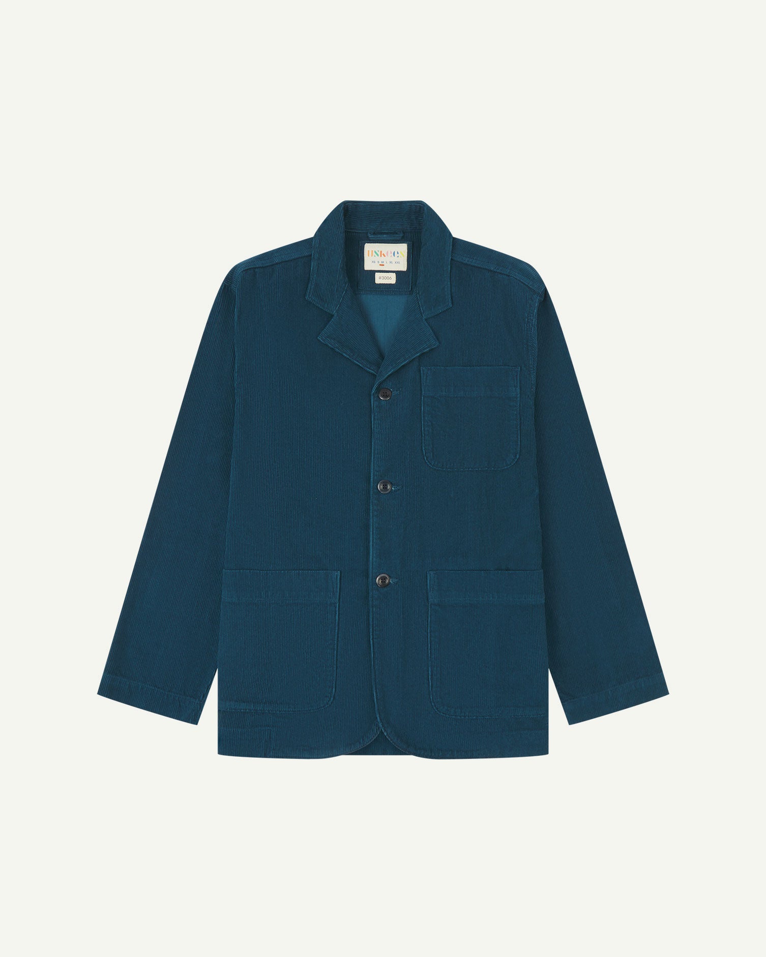 Flat front view of men's corduroy petrol blue blazer with 3 patch pockets from Uskees. Clearly showing corozo buttons and 3 pockets on the front.