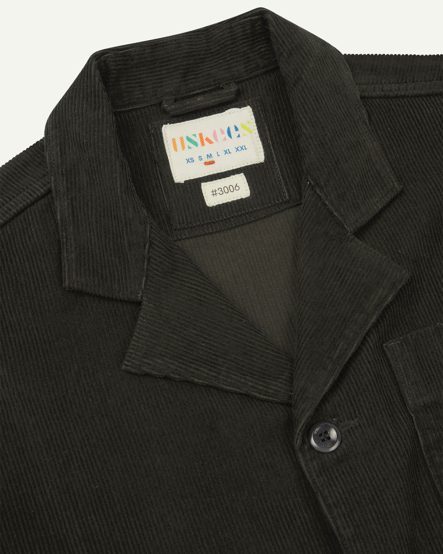 Close-up front view of organic cord green-brown (seaweed) blazer showing the collar, lapels and Uskees brand label.