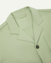 Close-up top-half view of #3006, silver-green organic cotton-drill blazer. With focus on collar, lapels and corozo buttons.