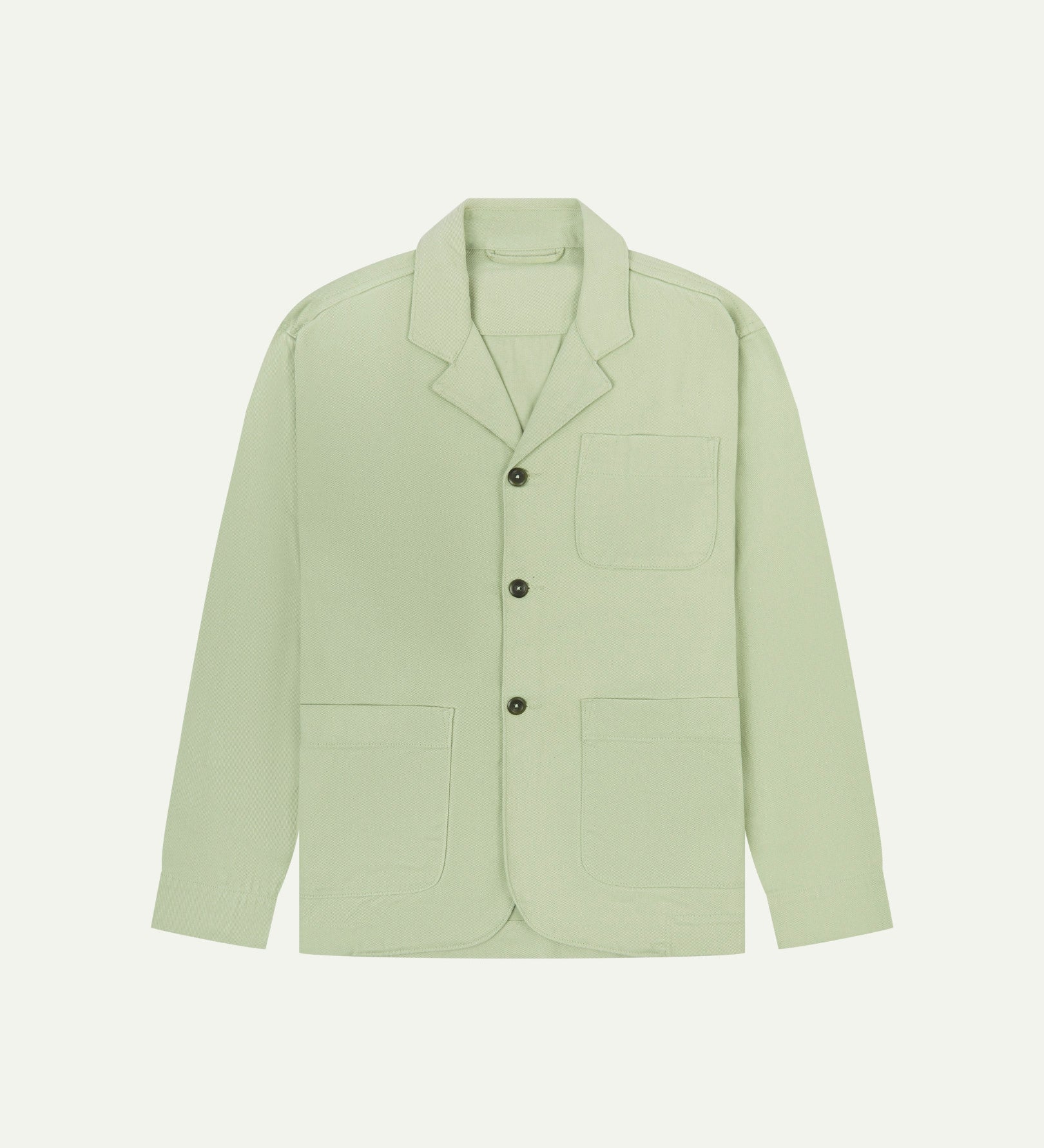 Silver-green buttoned organic cotton-drill blazer from Uskees with clear view of three patch pockets and corozo buttons.