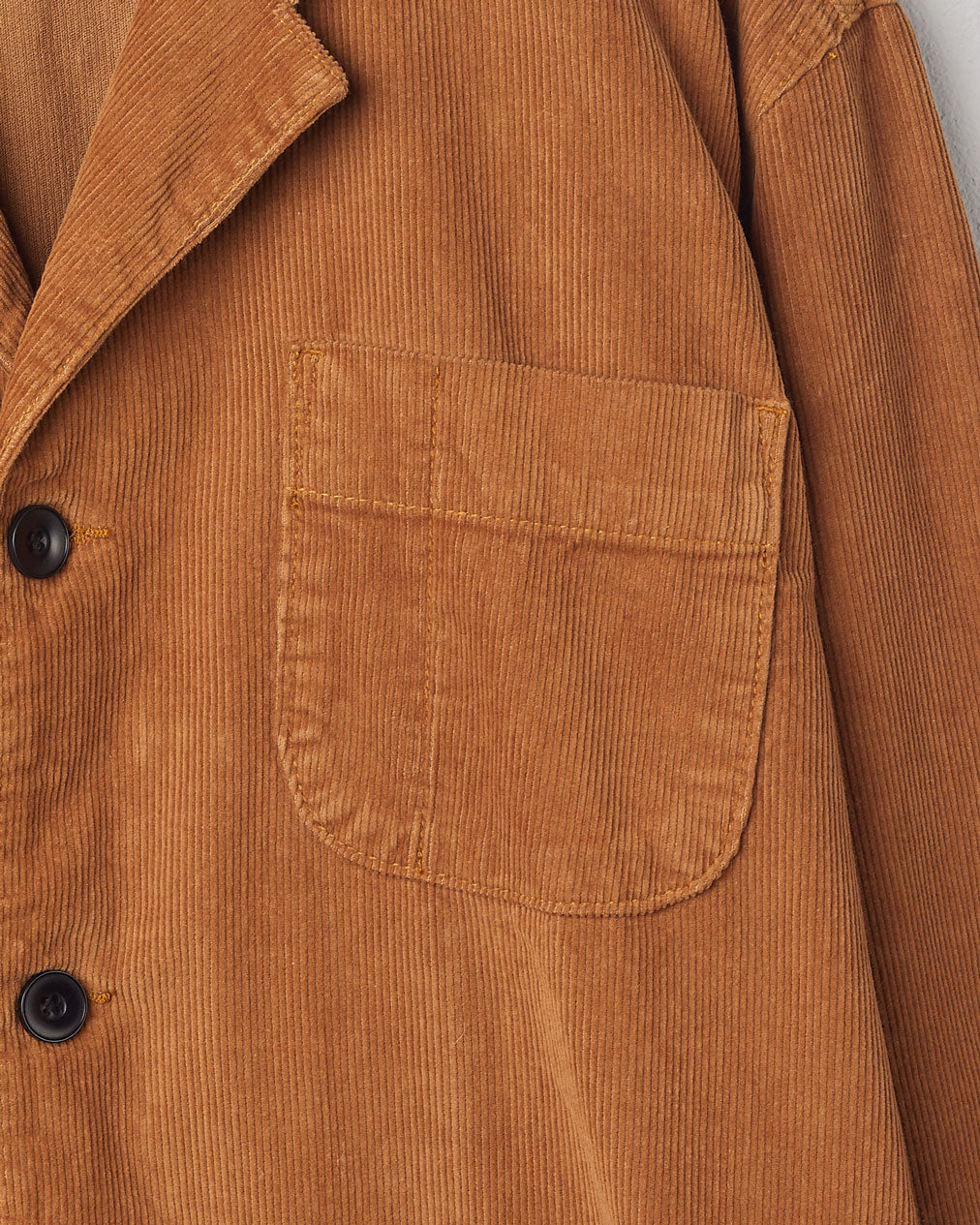 Mid-left view of #3006 Uskees blazer in tan corduroy with focus on breast pocket and corozo buttons.