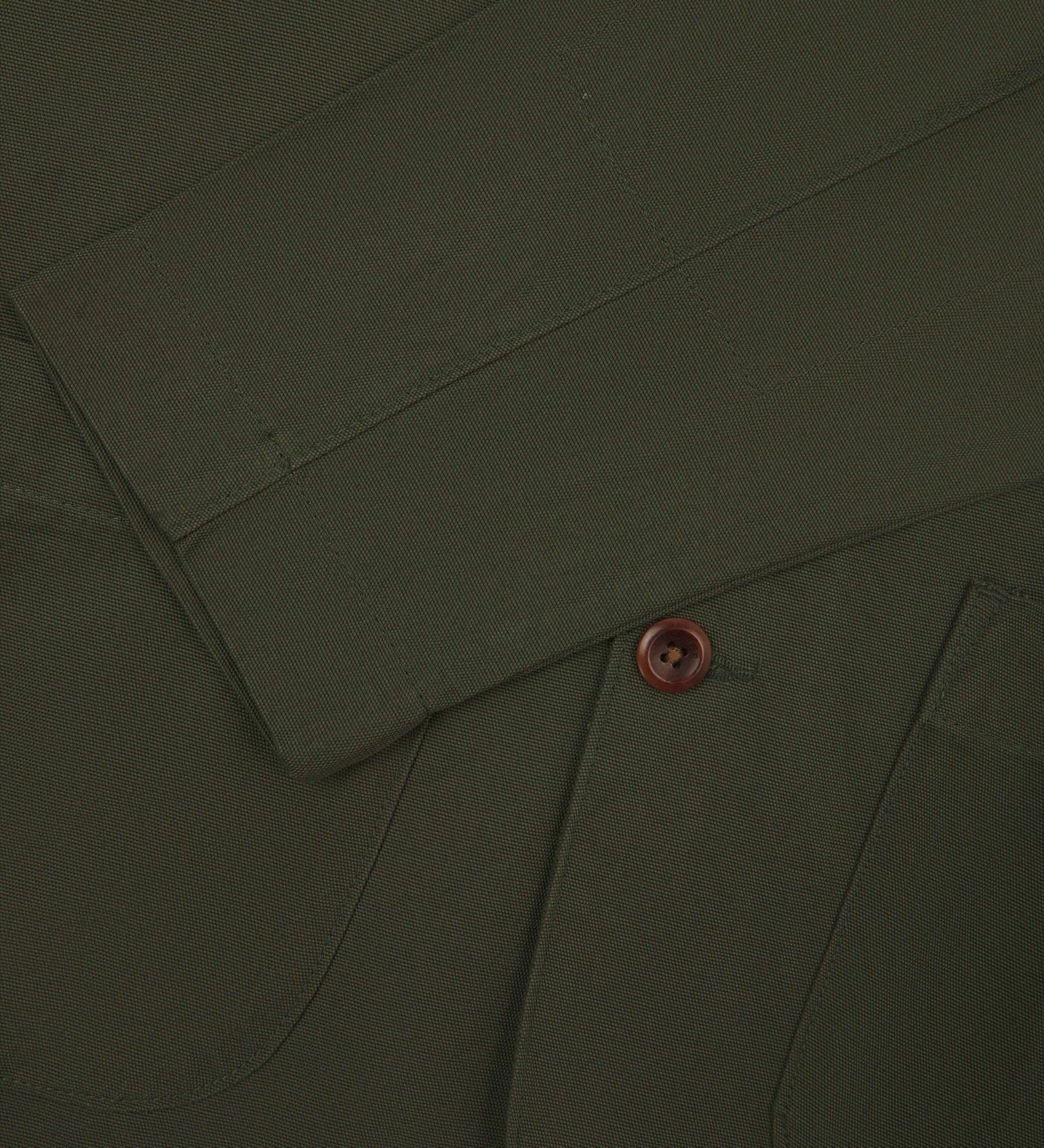 Close-up view of cuff and placket of organic cotton, vine green blazer from Uskees.