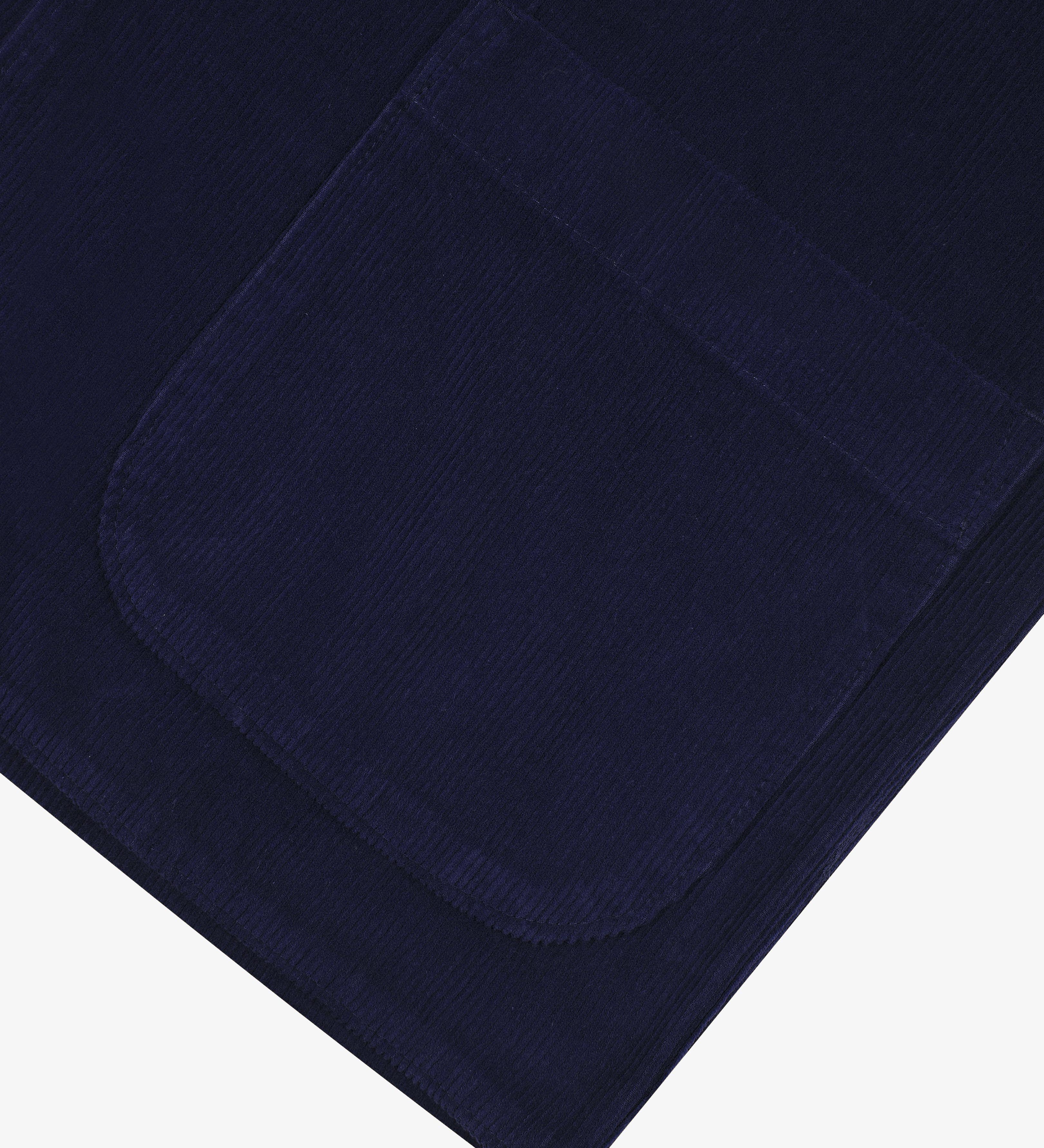 Close-up of a navy blue cord blazer showing the pocket detail, presented on a white background