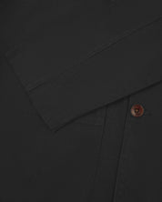 Close flat shot of dark grey organic cotton men's blazer from Uskees showing cuff and corozo button.