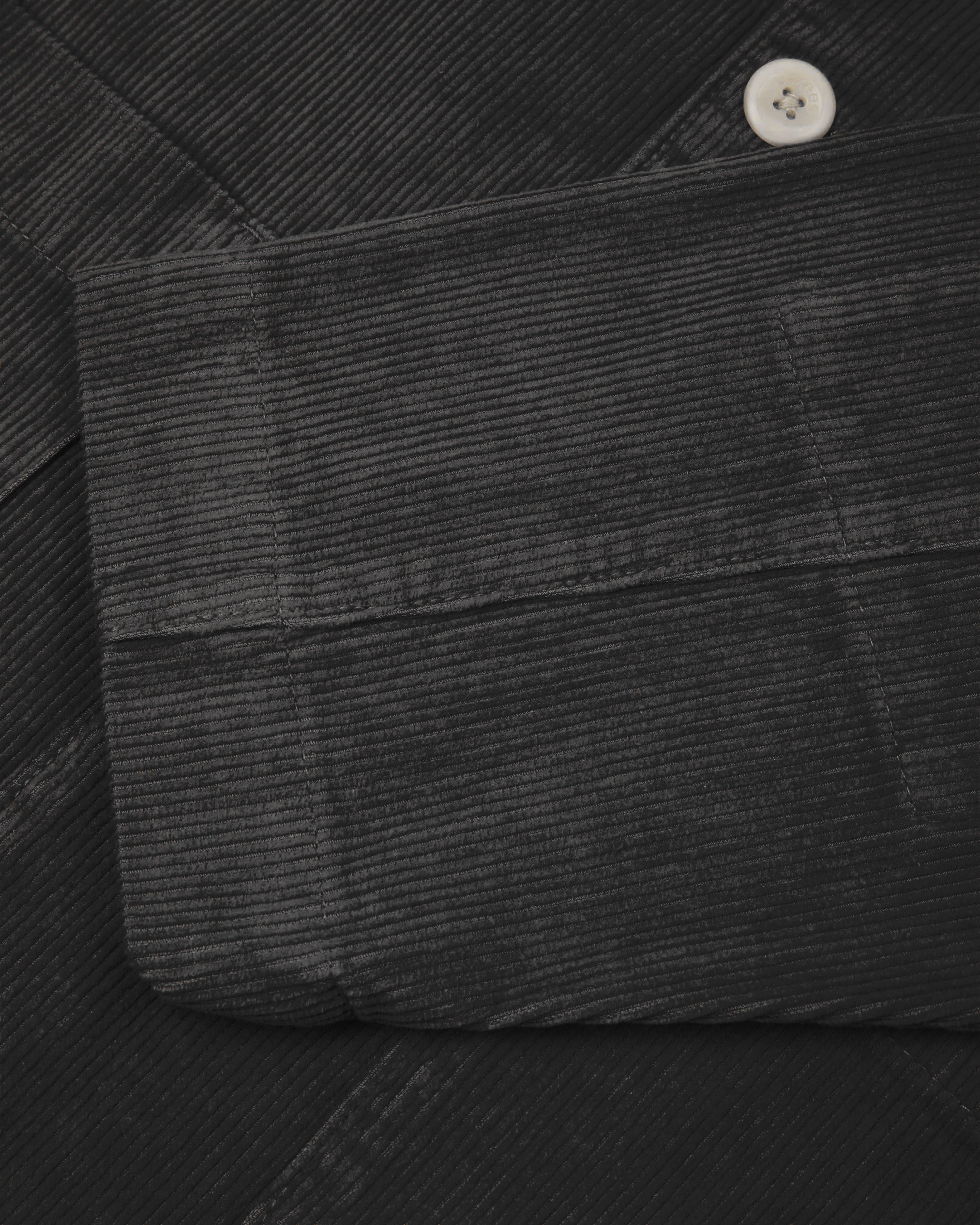 Flat front close view of dark grey #3006 corduroy blazer with view of cuff/sleeve and contrast corozo button.