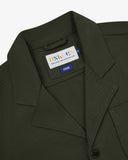 Front close up shot of Uskees dark green cotton drill blazer for men showing the collar, lapels and brand label.
