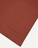 Close-up of a pocket on the chestnut drill Uskees blazer for men, presnted on a white background