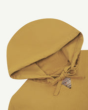 Closer look at the hood of the Uskees organic cotton smock in acid yellow (citronella) showing hood, hood drawstring and quadruply stitched neck area.