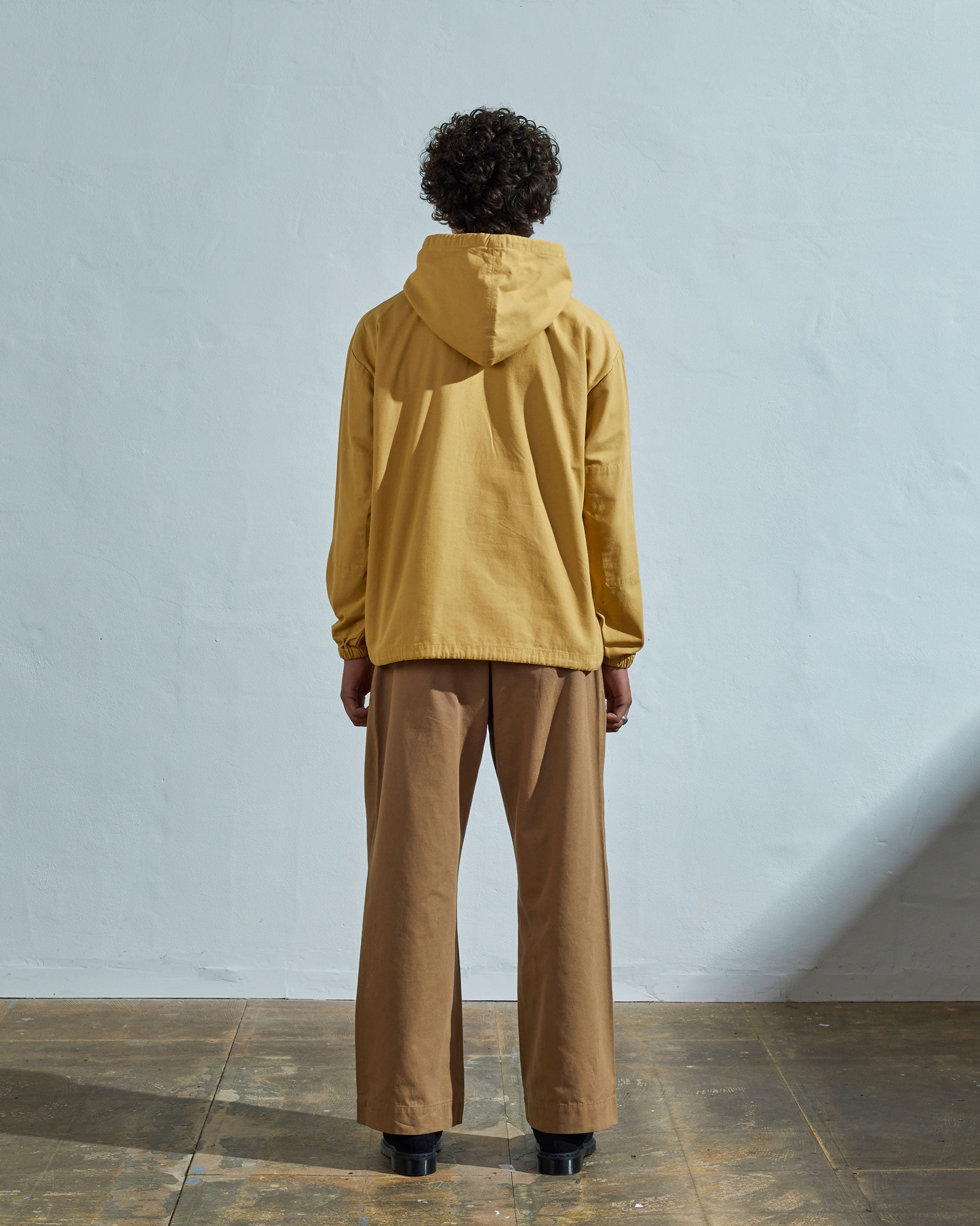 Full-length rear view of #3008 smock in citronella yellow showing reinforced elbows and simple loose boxy design.