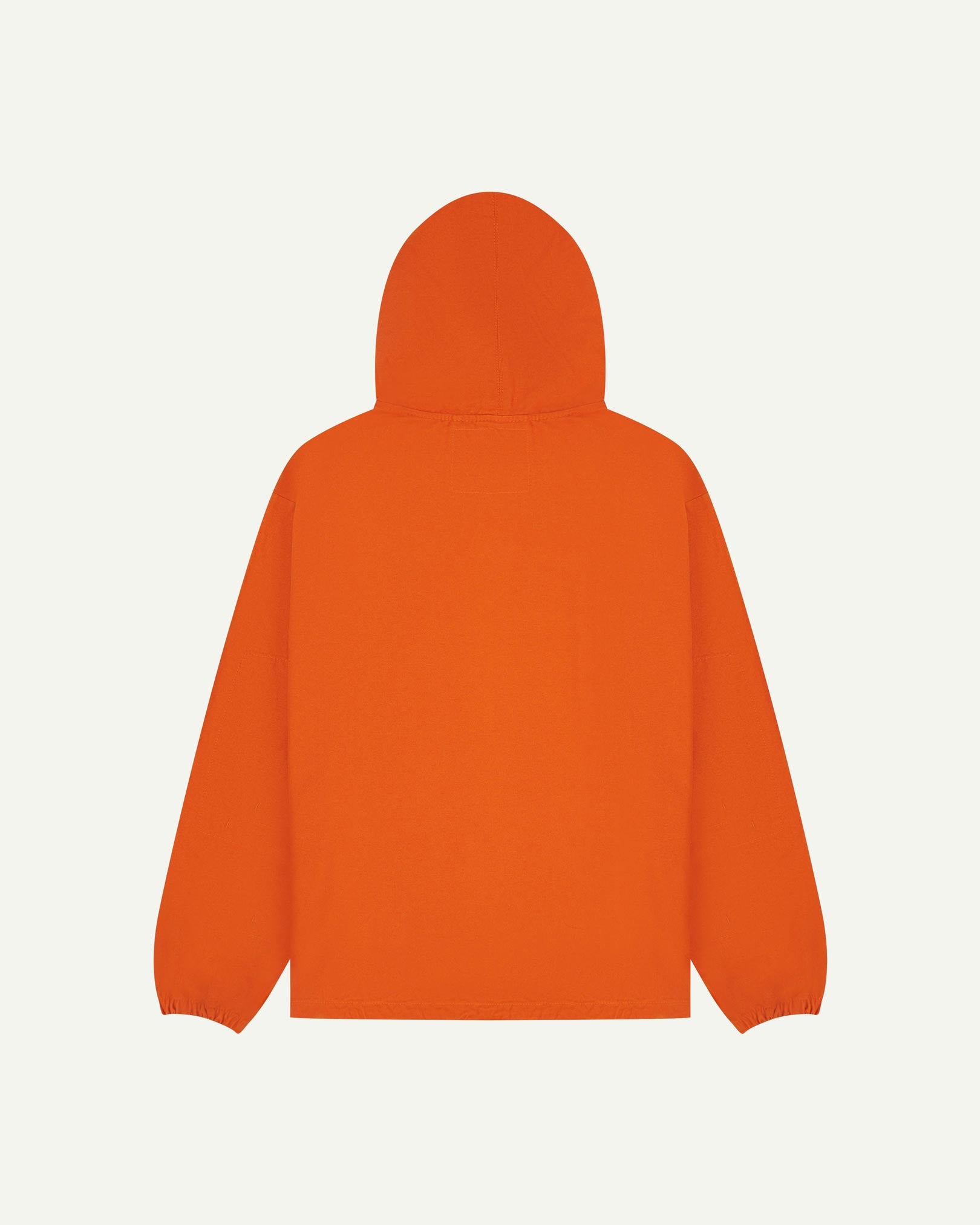 Back flat shot of Uskees gold-orange organic cotton smock showing reinforced elbows, back of hood and loose silhouette.