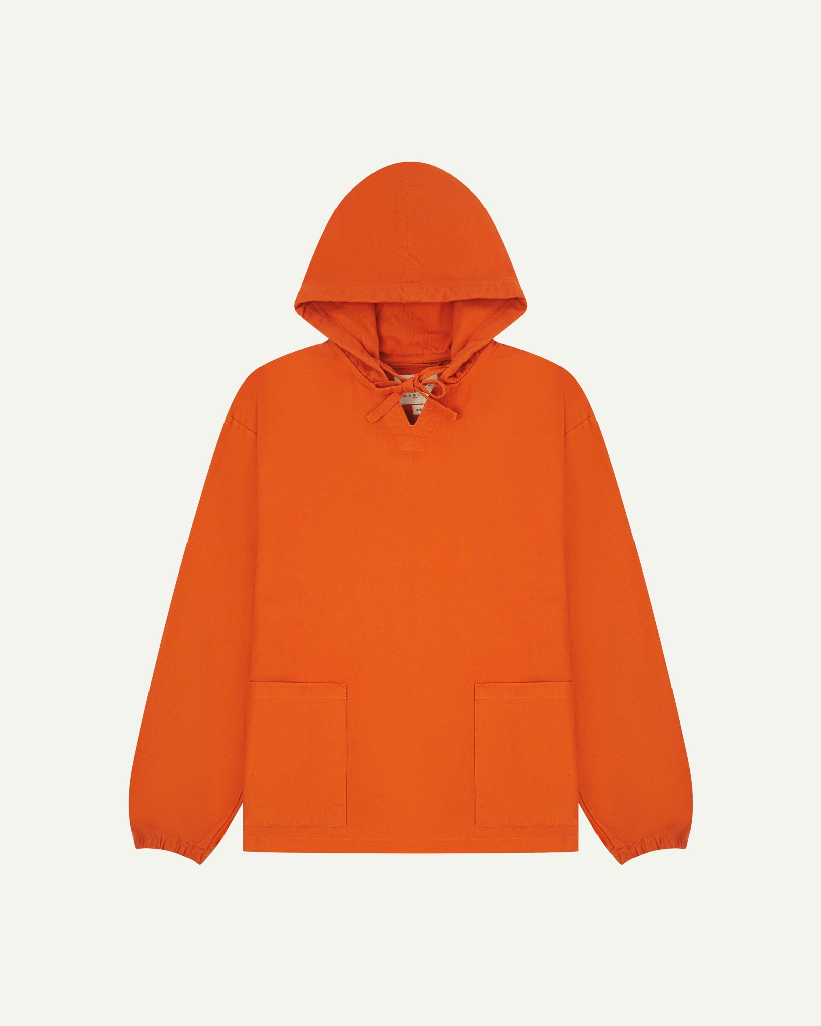 Full-length front flat view of gold-orange smock from Uskees, showing large front hip pockets, drawstring base and hood.