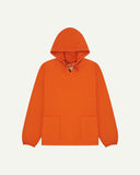 Full-length front flat view of gold-orange smock from Uskees, showing large front hip pockets, drawstring base and hood.