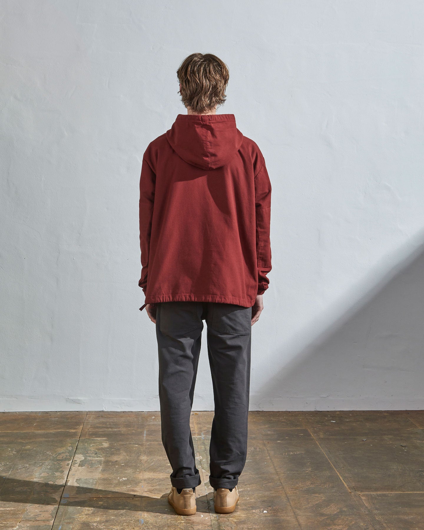 Full-length rear view of #3008 smock in maroon-red showing reinforced elbows and simple loose boxy design.