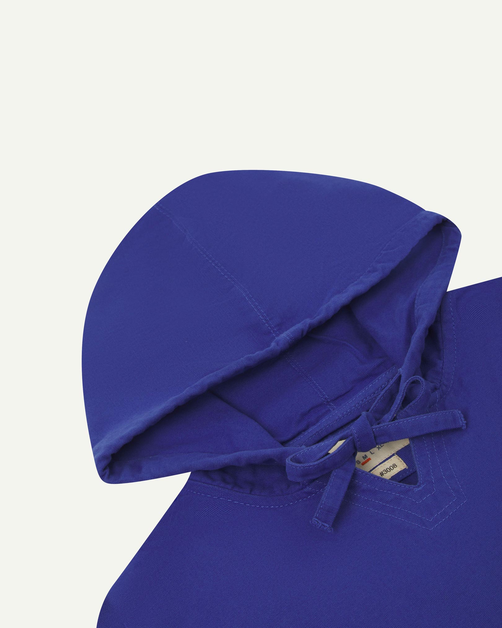 Closer look at the hood of the Uskees organic cotton smock in ultra blue showing hood, hood drawstring and quadruply stitched neck area.