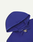 Closer look at the hood of the Uskees organic cotton smock in ultra blue showing hood, hood drawstring and quadruply stitched neck area.