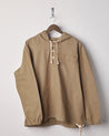 Front view of khaki coloured buttoned smock from Uskees with deep front pockets. Presented on hanger with white backdrop.