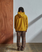 Full-length back view of model wearing Uskees yellow coloured buttoned smock.
