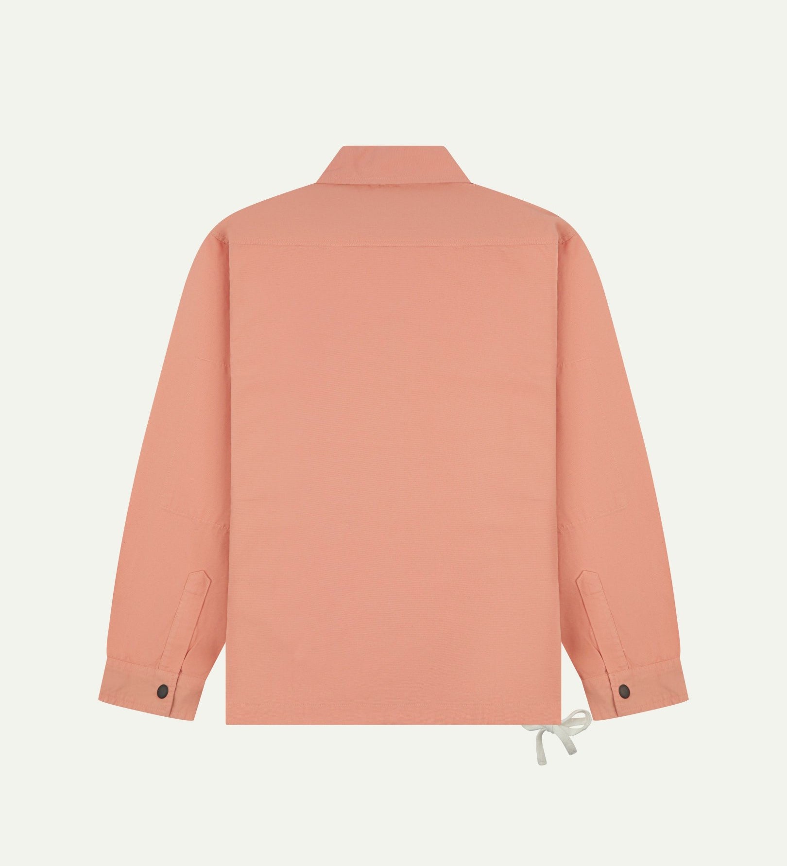 Full back view of Uskees pink-orange (coral) organic cotton coach jacket showing reinforced elbows and simple design.