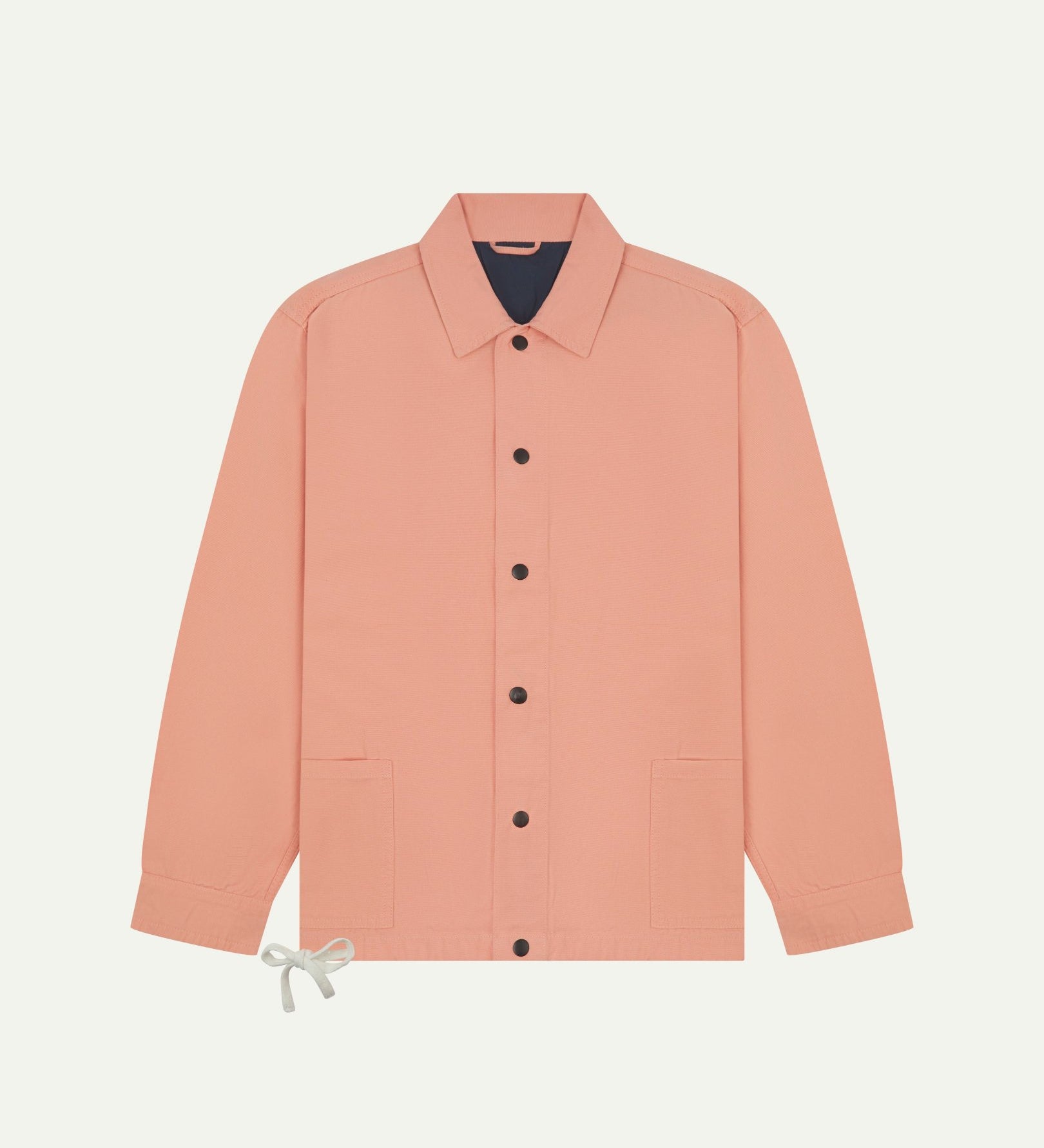 Full front view of Uskees coral organic cotton coach jacket showing sharp, contemporary detailing including 2 patch pockets, drawstring base and popper fastening.