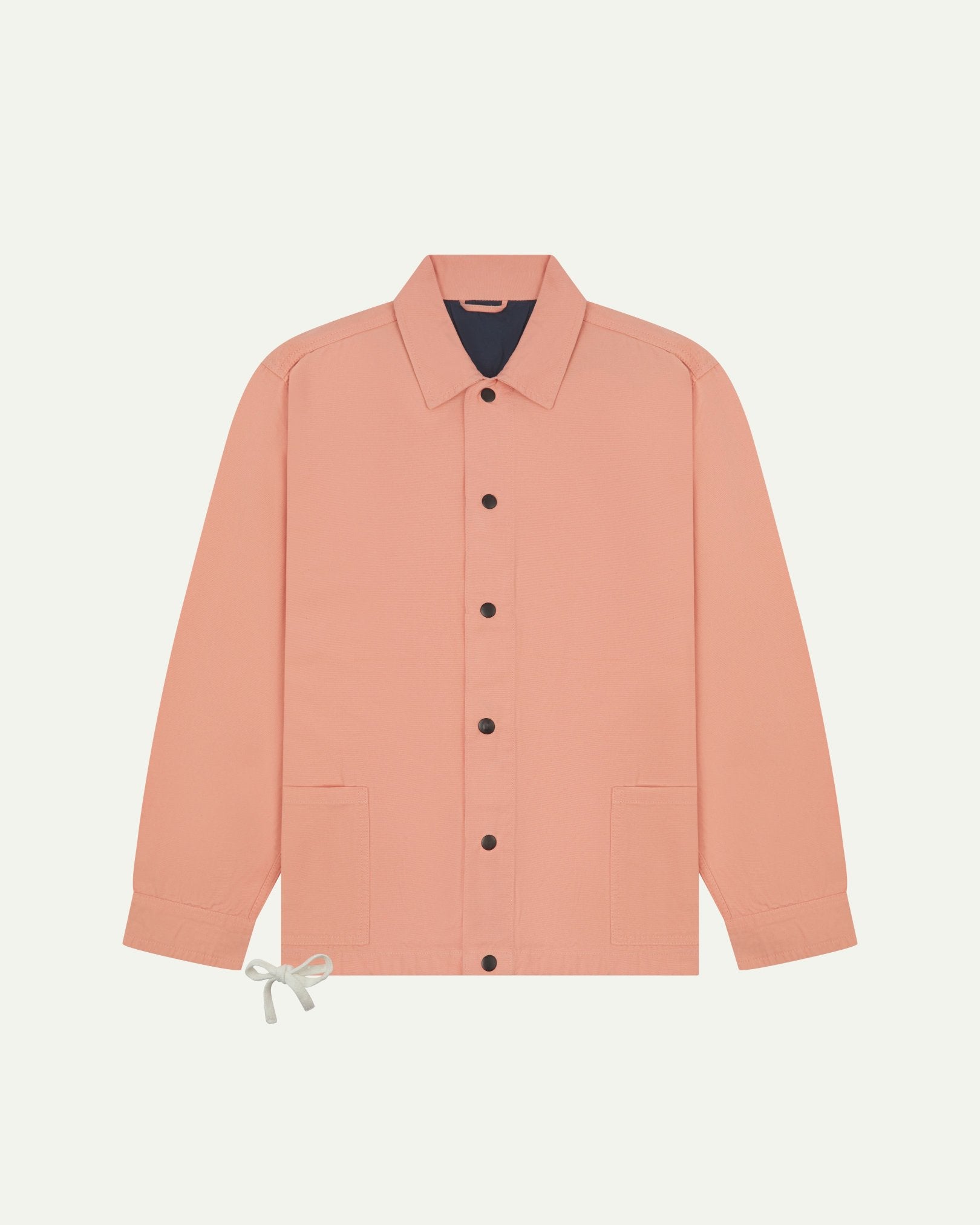 Full front view of Uskees coral organic cotton coach jacket showing sharp, contemporary detailing including 2 patch pockets, drawstring base and popper fastening.