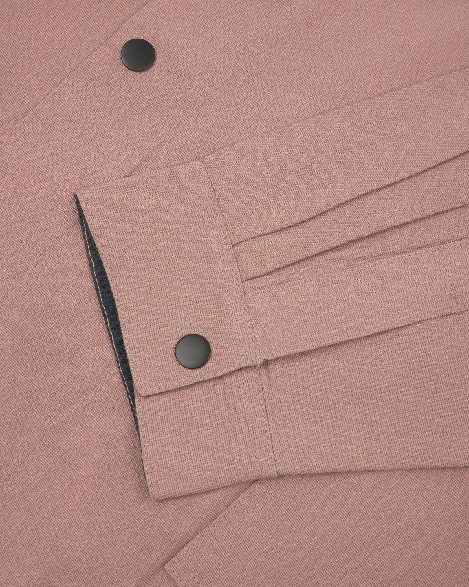 Sleeve view of Uskees 3013 dusty pink organic cotton coach jacket with focus on placket, cuff and popper buttons.