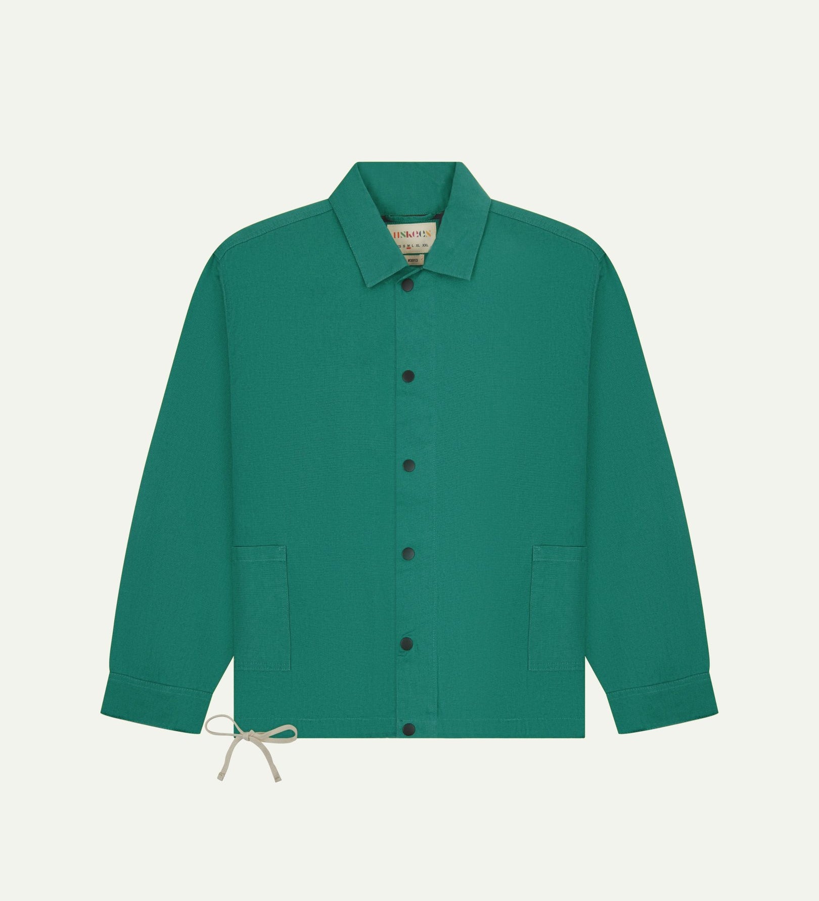 Full front view of Uskees foam green organic cotton coach jacket showing sharp, contemporary detailing including 2 patch pockets, drawstring base and popper fastening.