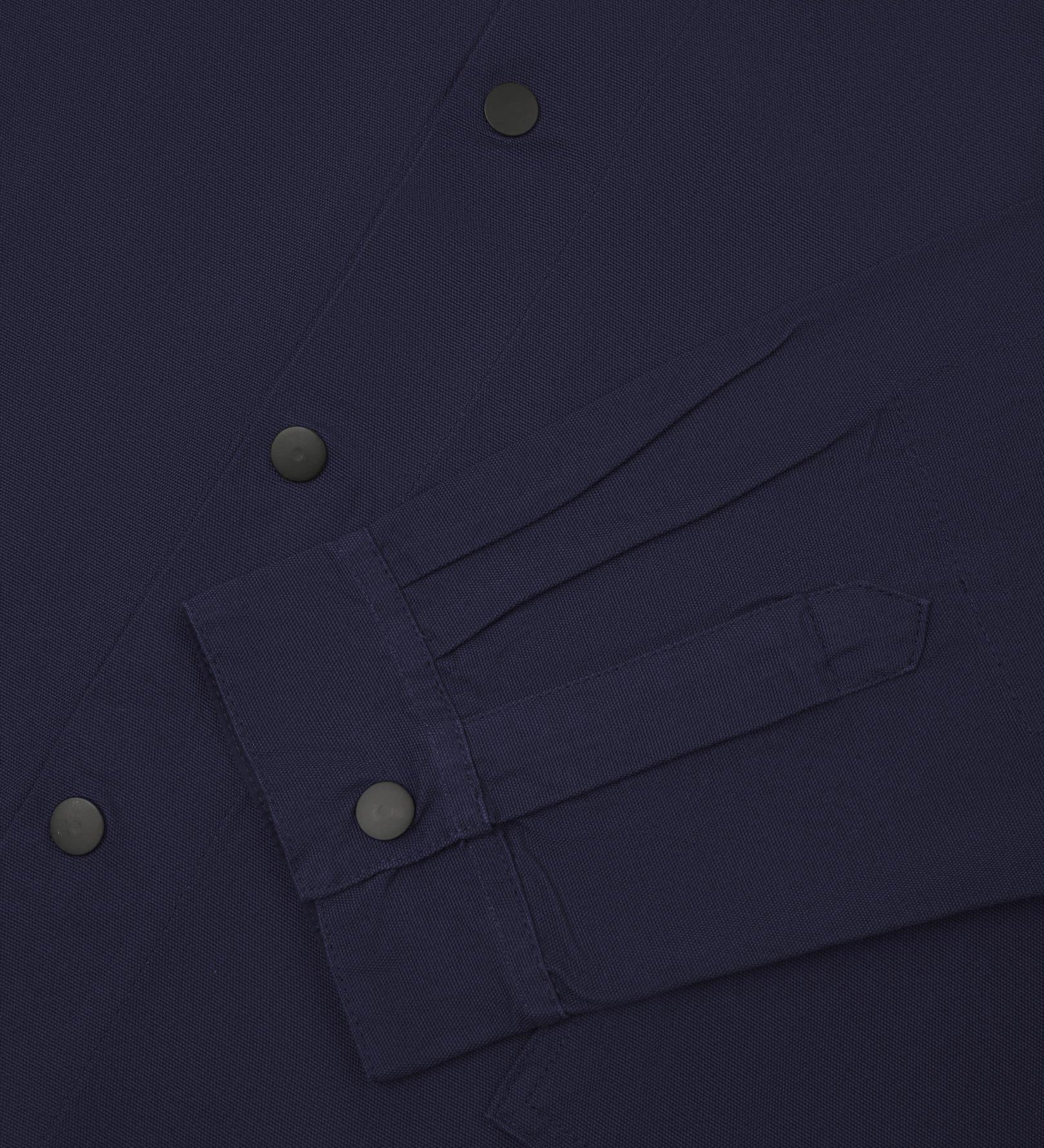 Sleeve view of Uskees 3013 dark blue organic cotton coach jacket with focus on placket, cuff and popper buttons.