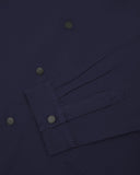 Sleeve view of Uskees 3013 dark blue organic cotton coach jacket with focus on placket, cuff and popper buttons.