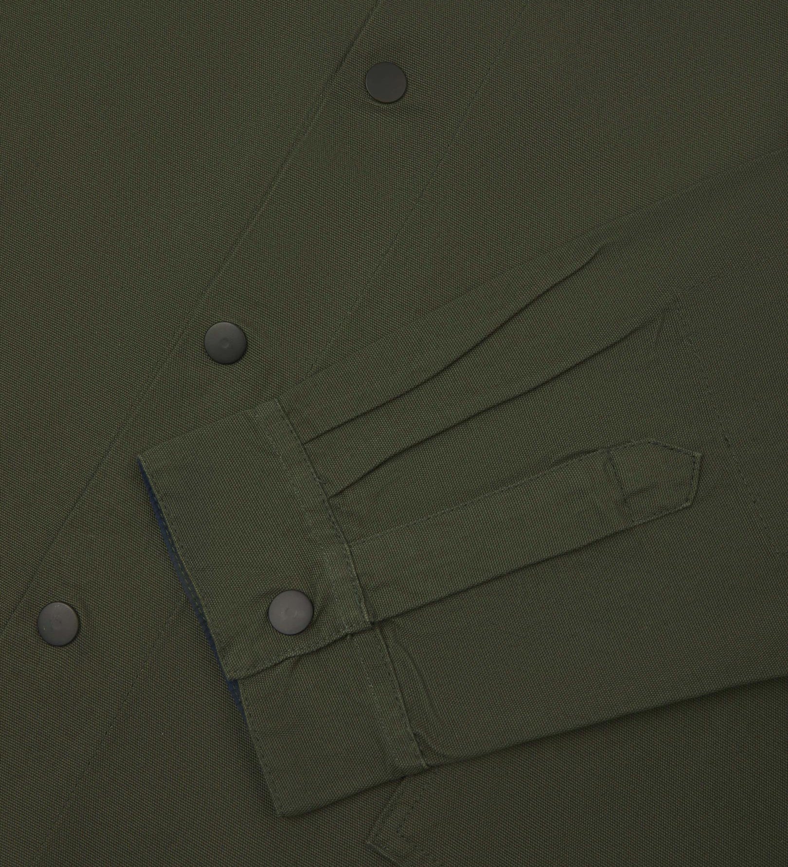Sleeve view of Uskees 3013 vine green organic cotton coach jacket with focus on placket, cuff and popper buttons.