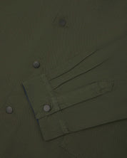 Sleeve view of Uskees 3013 vine green organic cotton coach jacket with focus on placket, cuff and popper buttons.