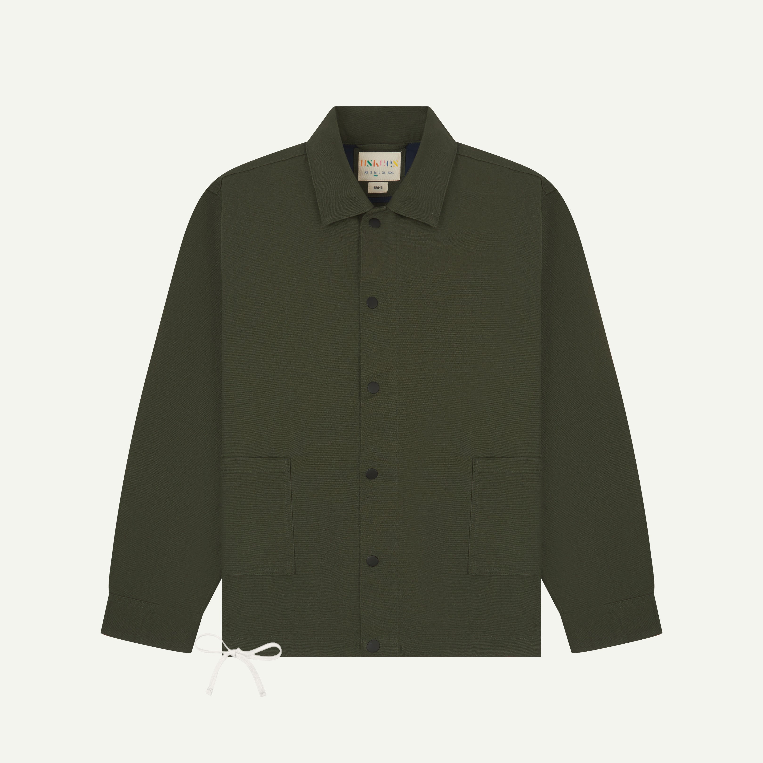 front flat shot of uskees dark green coach jacket with popper fastening and adjustable drawstring base