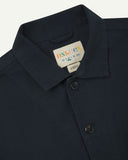 Front close view of blueberry-coloured organic cotton drill commuter blazer showing collar and Uskees branding label.