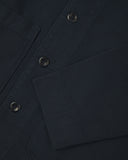 Close up view of dark blue organic cotton drill commuter blazer showing front buttons and cuff detail