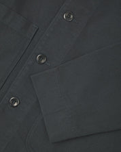 Close up view of charcoal-grey organic cotton drill commuter blazer showing front buttons and cuff detail.