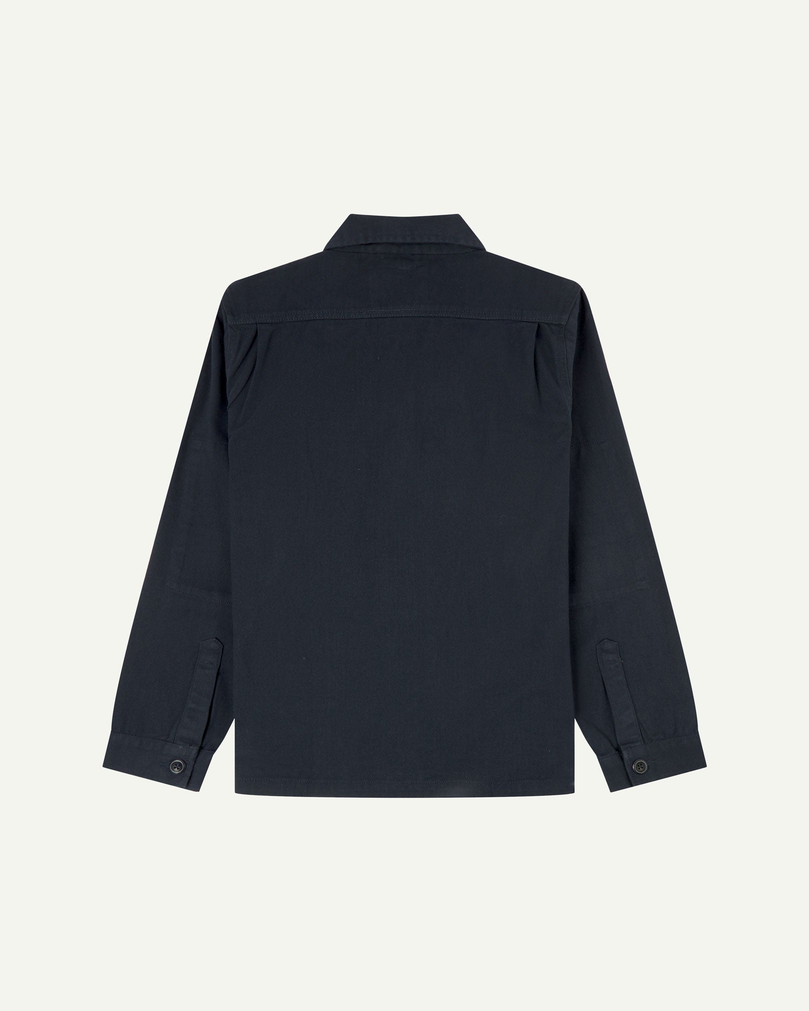 Reverse of dark blue (blueberry) buttoned organic cotton-drill overshirt from Uskees showing reinforced elbows and boxy silhouette.