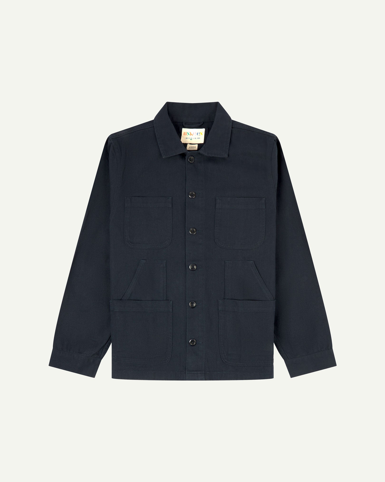 Dark blue (blueberry) buttoned organic cotton-drill overshirt from Uskees with clear view of layered patch pockets, reinforced elbows and Uskees branding label.