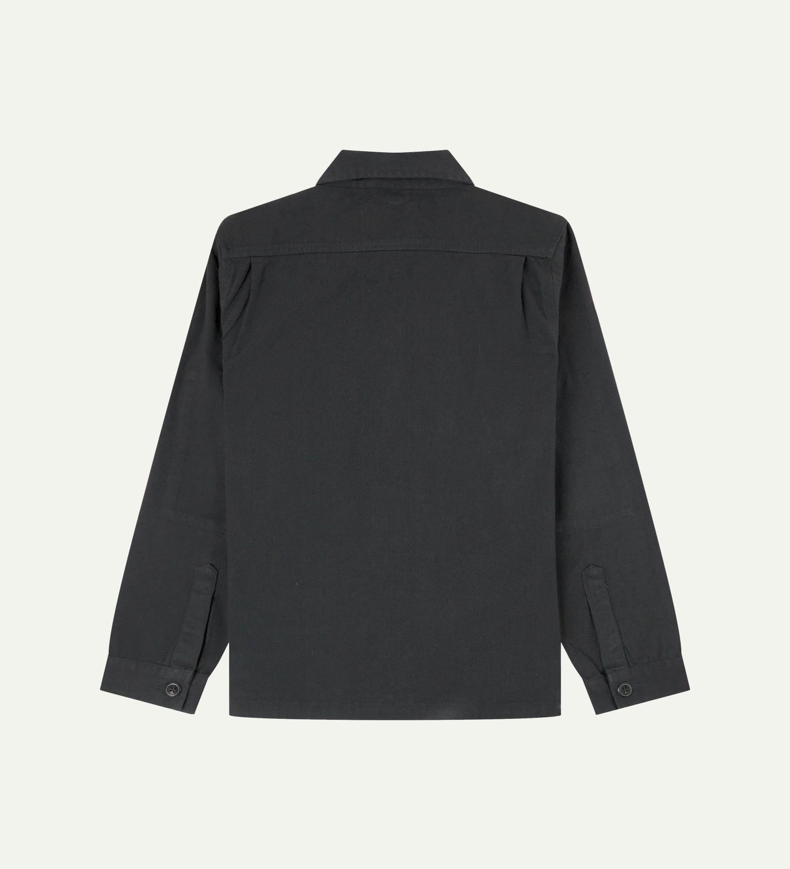 Reverse of charcoal-grey buttoned organic cotton drill overshirt from Uskees showing reinforced elbows and boxy silhouette.