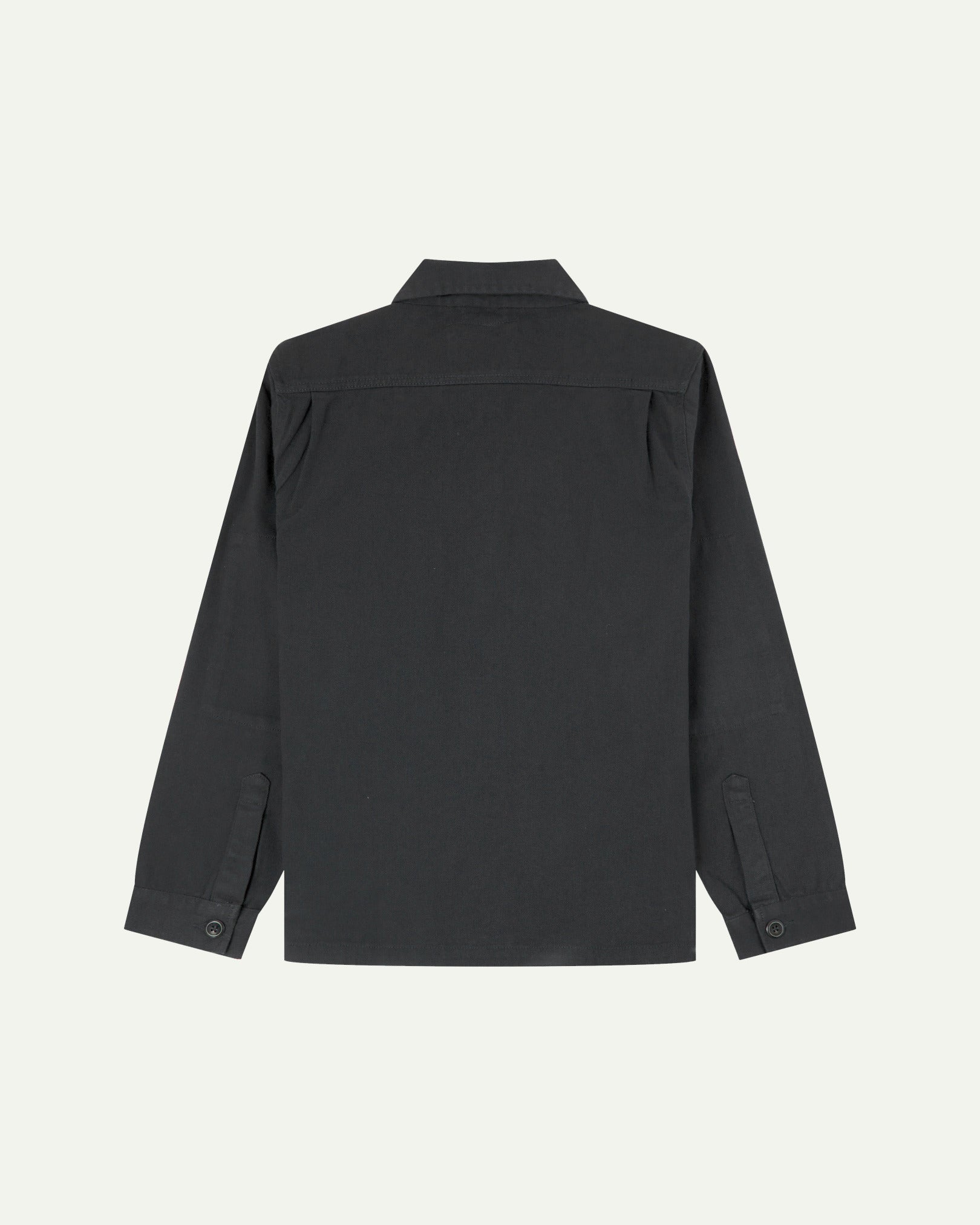 Reverse of charcoal-grey buttoned organic cotton drill overshirt from Uskees showing reinforced elbows and boxy silhouette.