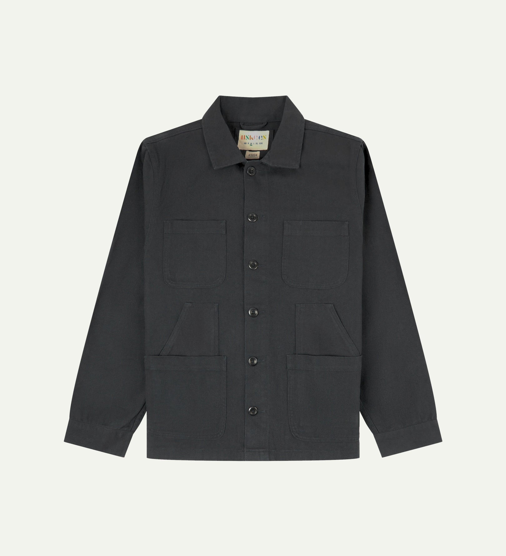 Charcoal-grey buttoned organic cotton drill overshirt from Uskees with clear view of layered patch pockets, reinforced elbows and Uskees branding label.