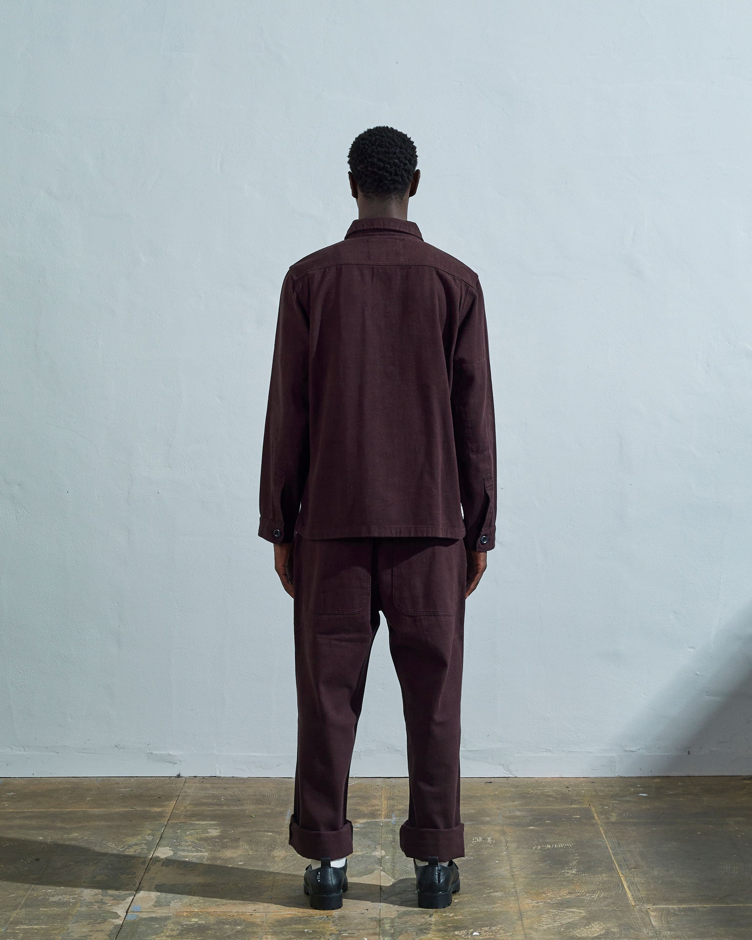 Full-length rear view of #3024, dark plum-coloured organic cotton-drill over shirt with reinforced elbows.