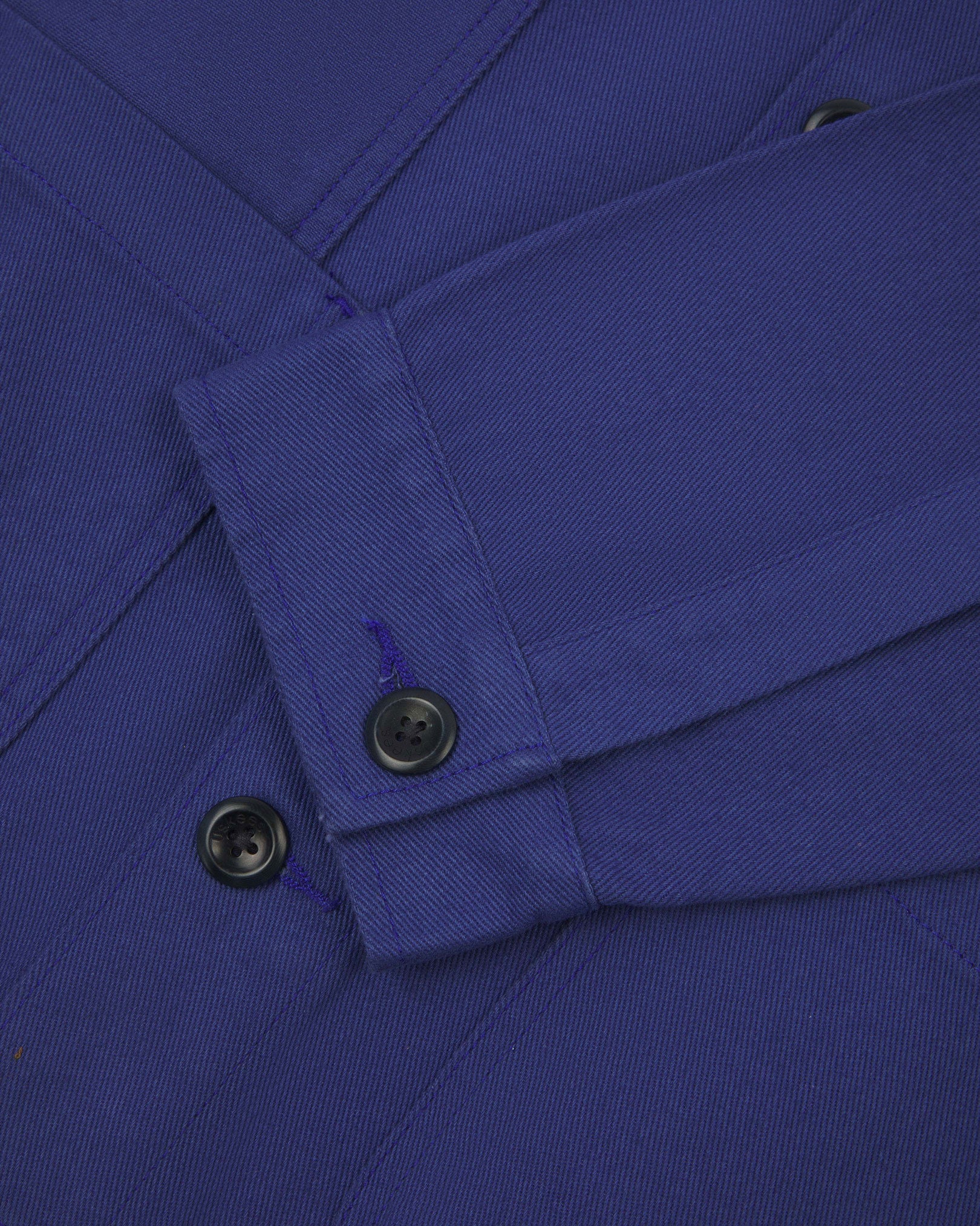 Closer detail view of multiple layered patch pockets, cuff detailing, corozo buttons and extra durable weave of the organic cotton drill fabric.