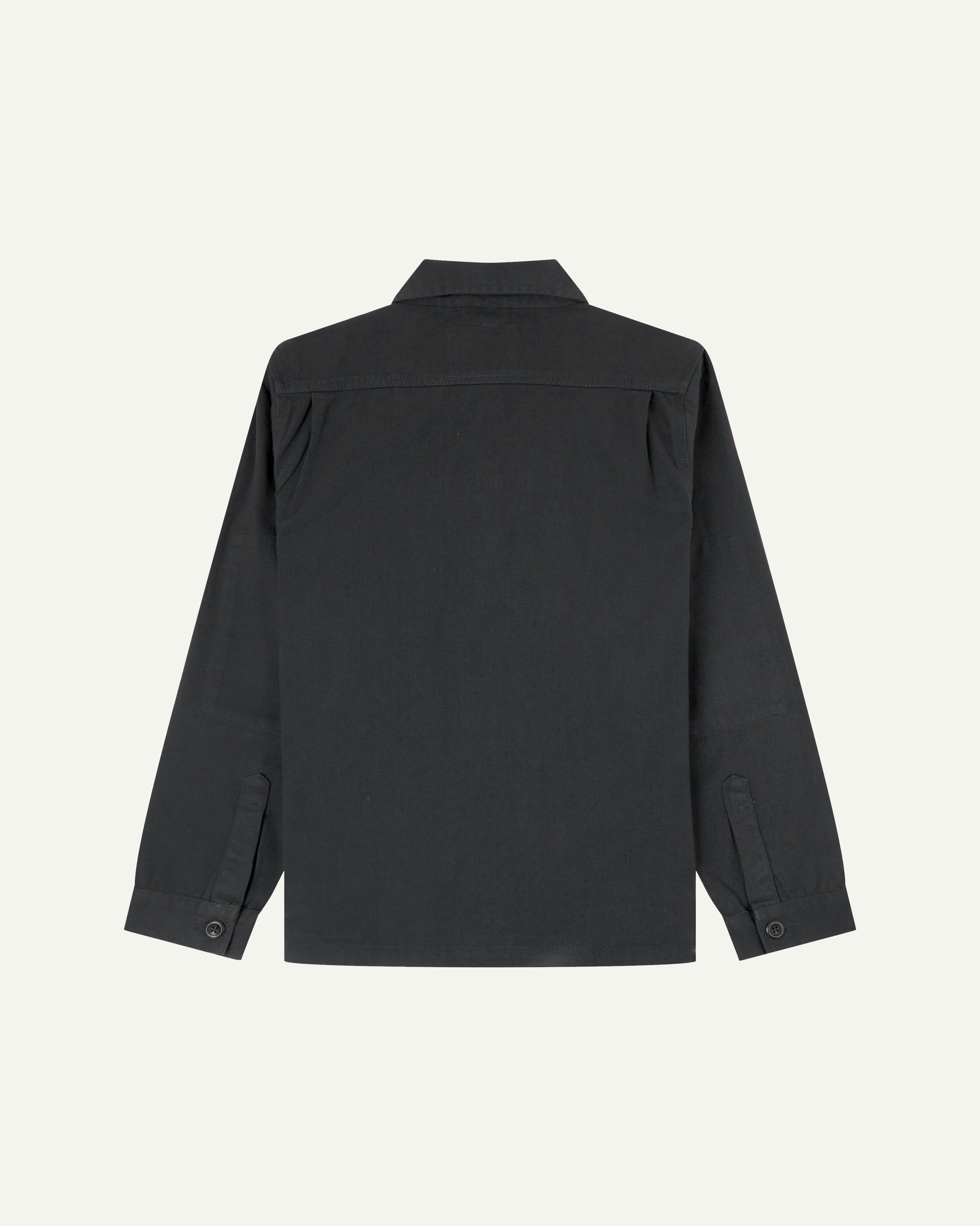 Reverse of charcoal-grey buttoned organic cotton drill overshirt from Uskees showing reinforced elbows and boxy silhouette.