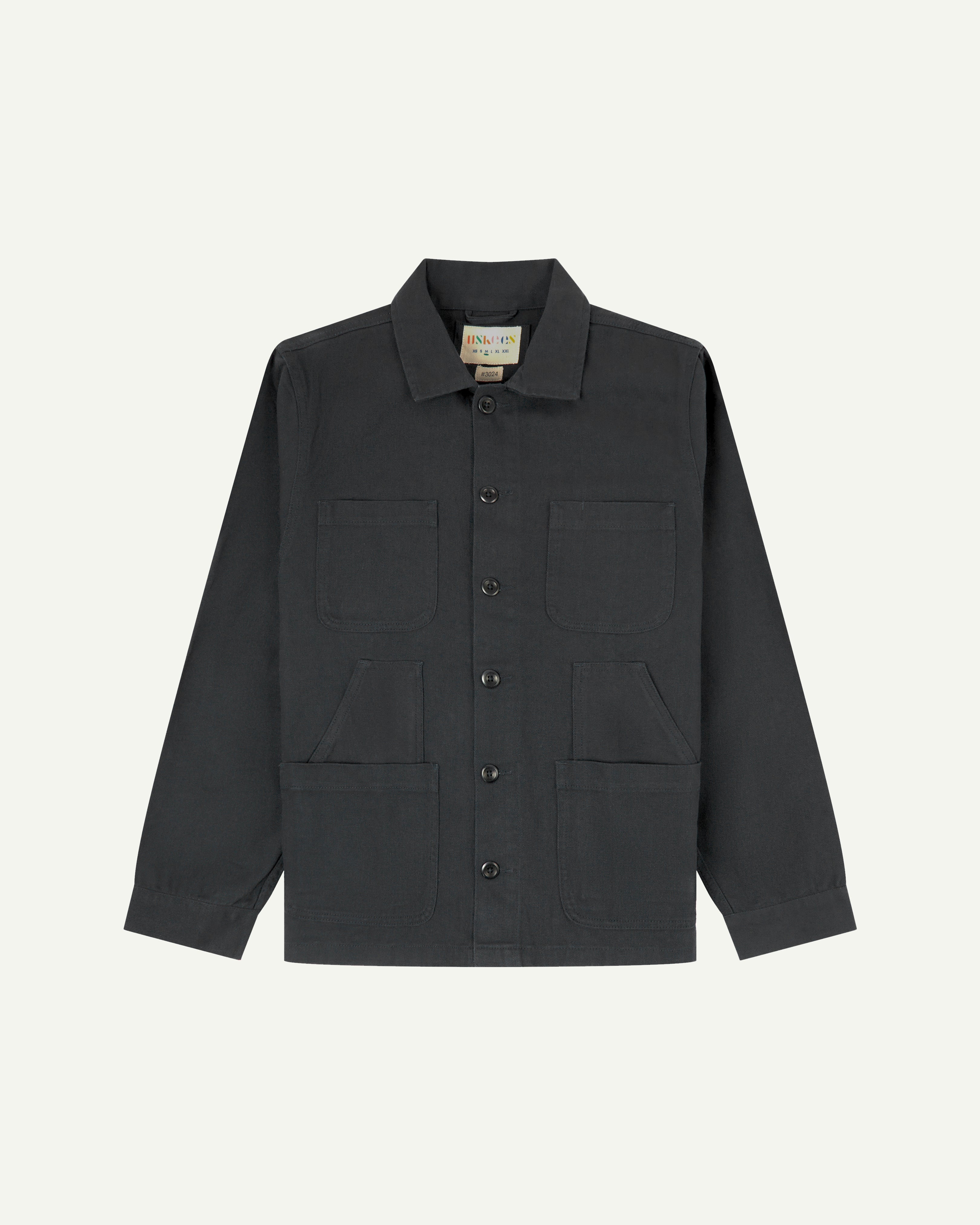 Charcoal-grey buttoned organic cotton drill overshirt from Uskees with clear view of layered patch pockets, reinforced elbows and Uskees branding label.