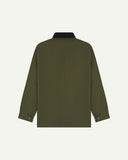Back view of Uskees cotton canvas chore jacket in coriander green with a navy blue collar showing the buttons on the cuffs 