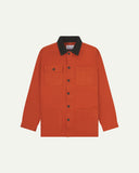 Front flat shot of Uskees cotton canvas chore jacket in golden orange with a dark brown corduroy collar. Clear view of the pockets and buttons.