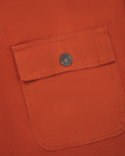 Close-up view of the breast flap pocket on the chest of the 3025 canvas chore jacket, showing a closer look at the metal buttons and the texture of the 510gsm organic cotton canvas.