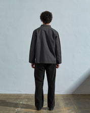 Full-length back view of model wearing 3027 charcoal-coloured organic canvas overshirt.