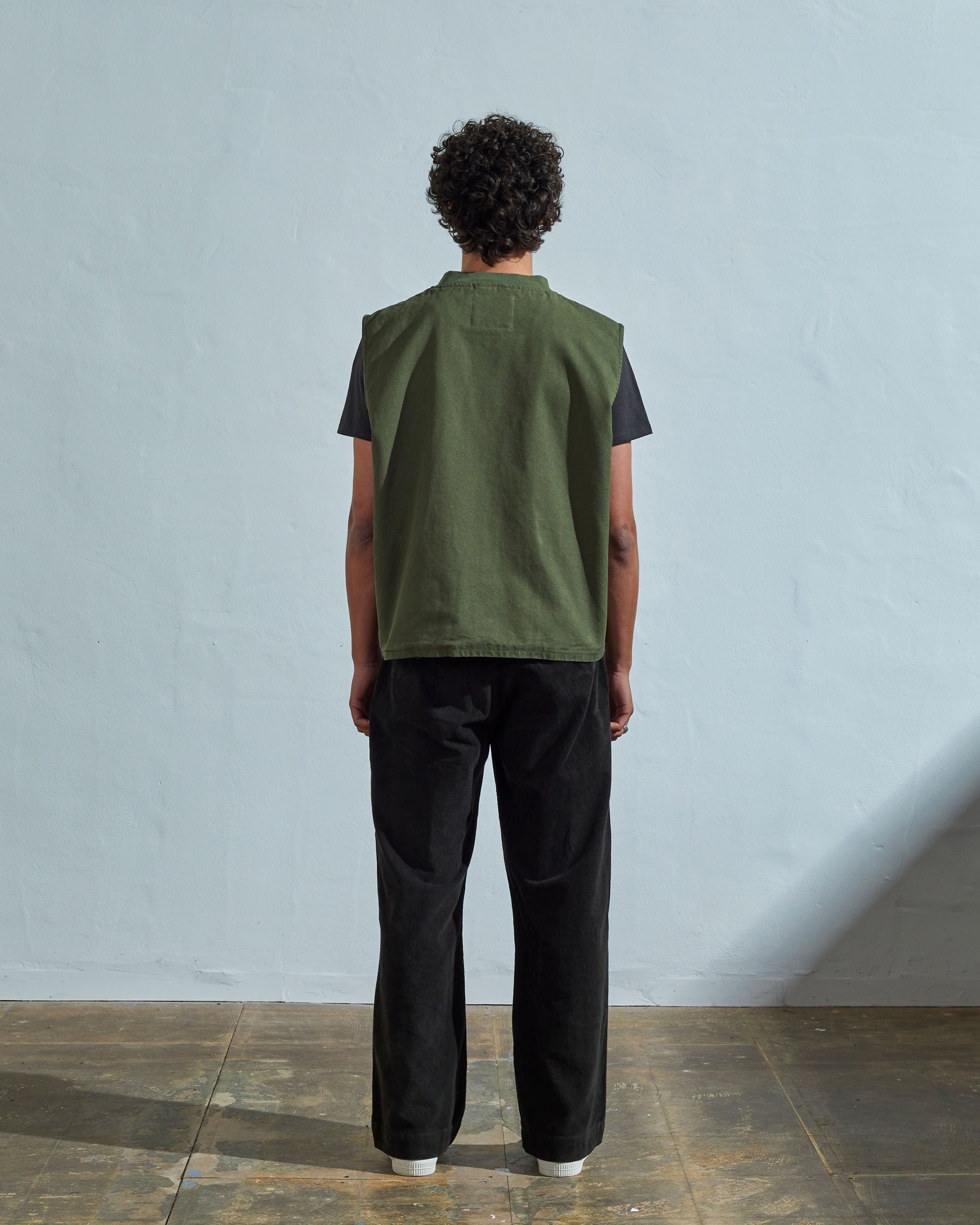 Full-length rear view of #3028, coriander-coloured organic canvas vest.